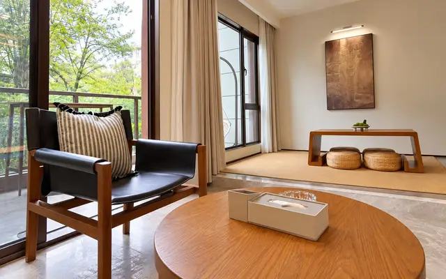 Loft sitting corner with armchair, low table and floor cushions